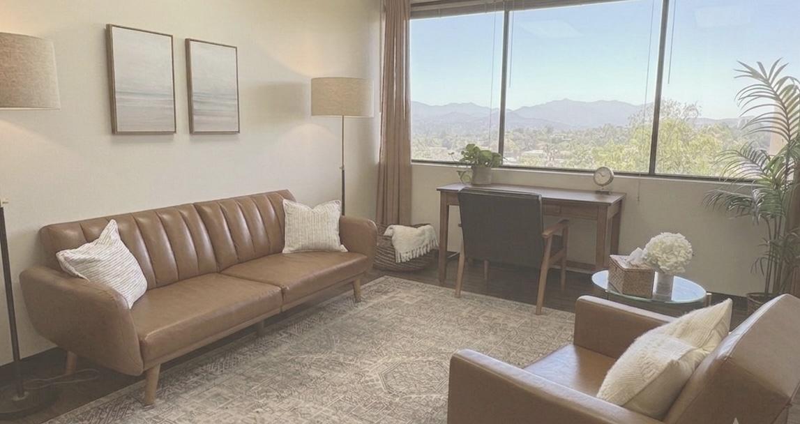 Kendra Hada's therapy office in Westlake Village with a leather couch and mountain views